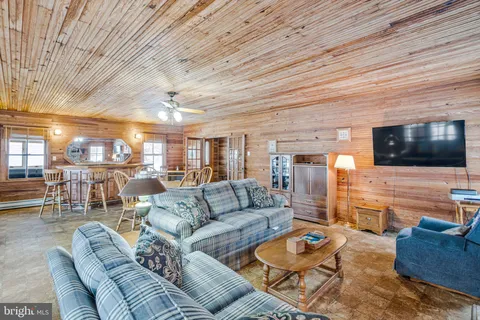 a view of a terrace with wooden floor and a bench