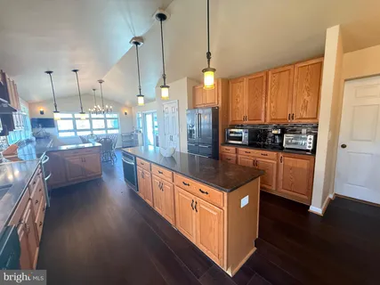 a view of a living room and chandelier fan wooden floor