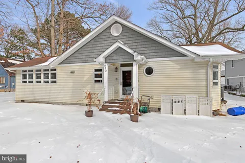 a kitchen with stainless steel appliances granite countertop wooden cabinets a stove top oven a sink and dishwasher a oven with wooden floor