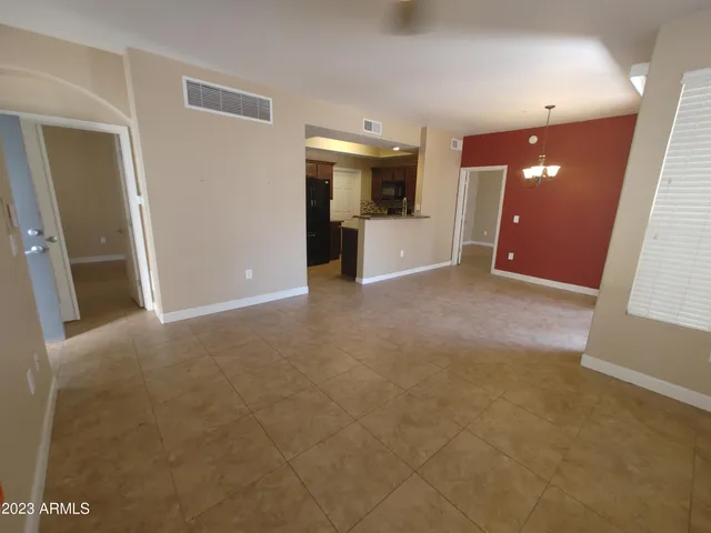 a view of a big room with closet and windows