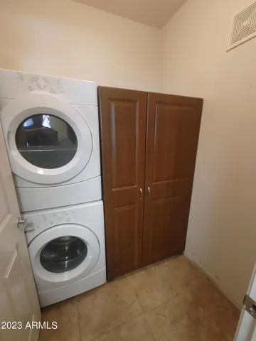 en empty room with windows and fan