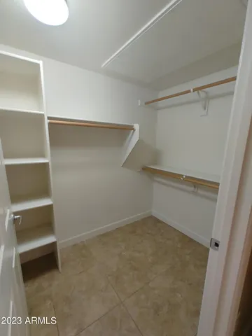 a bathroom with a granite countertop sink a toilet a mirror and bathtub