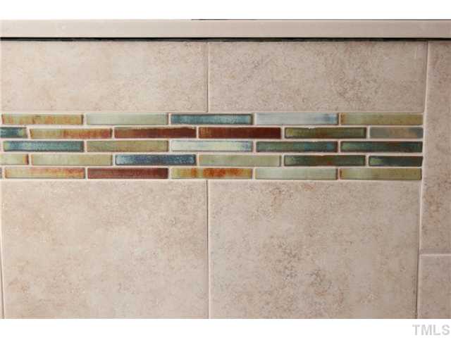 6920 Rex Road Holly Springs, NC 27540 - Photo 15 of 24 Detail of tile in master displays neutral background with Raku style irridescent glazed accent tile. Great possibilities for accent colors!