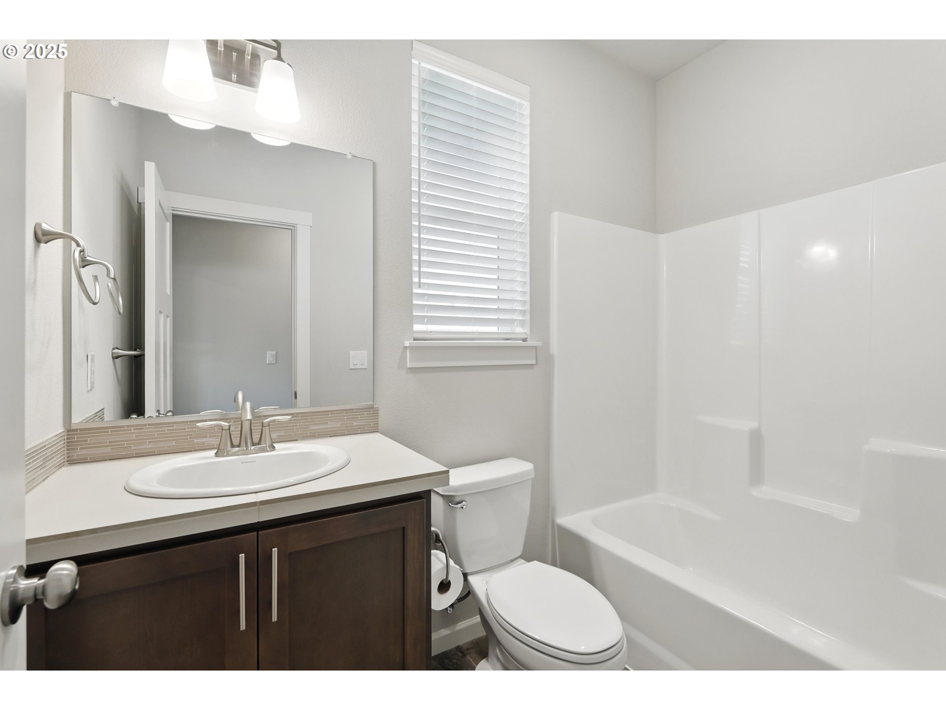 2582 Southwest Thomas Way Gresham, OR 97080 - Photo 29 of 36 a bathroom with a sink a toilet and shower