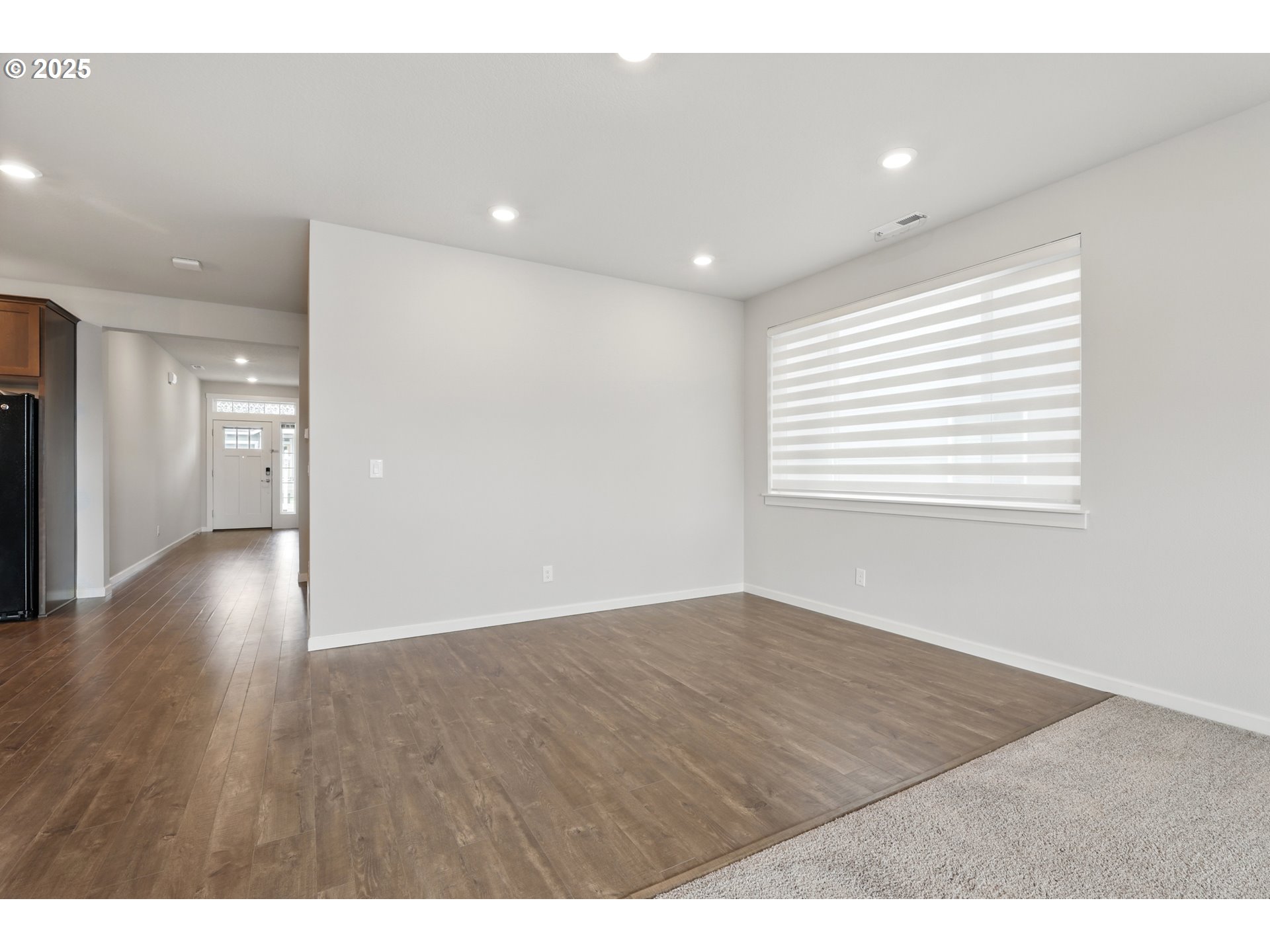 2582 Southwest Thomas Way Gresham, OR 97080 - Photo 8 of 36 a view of an empty room with wooden floor and a window