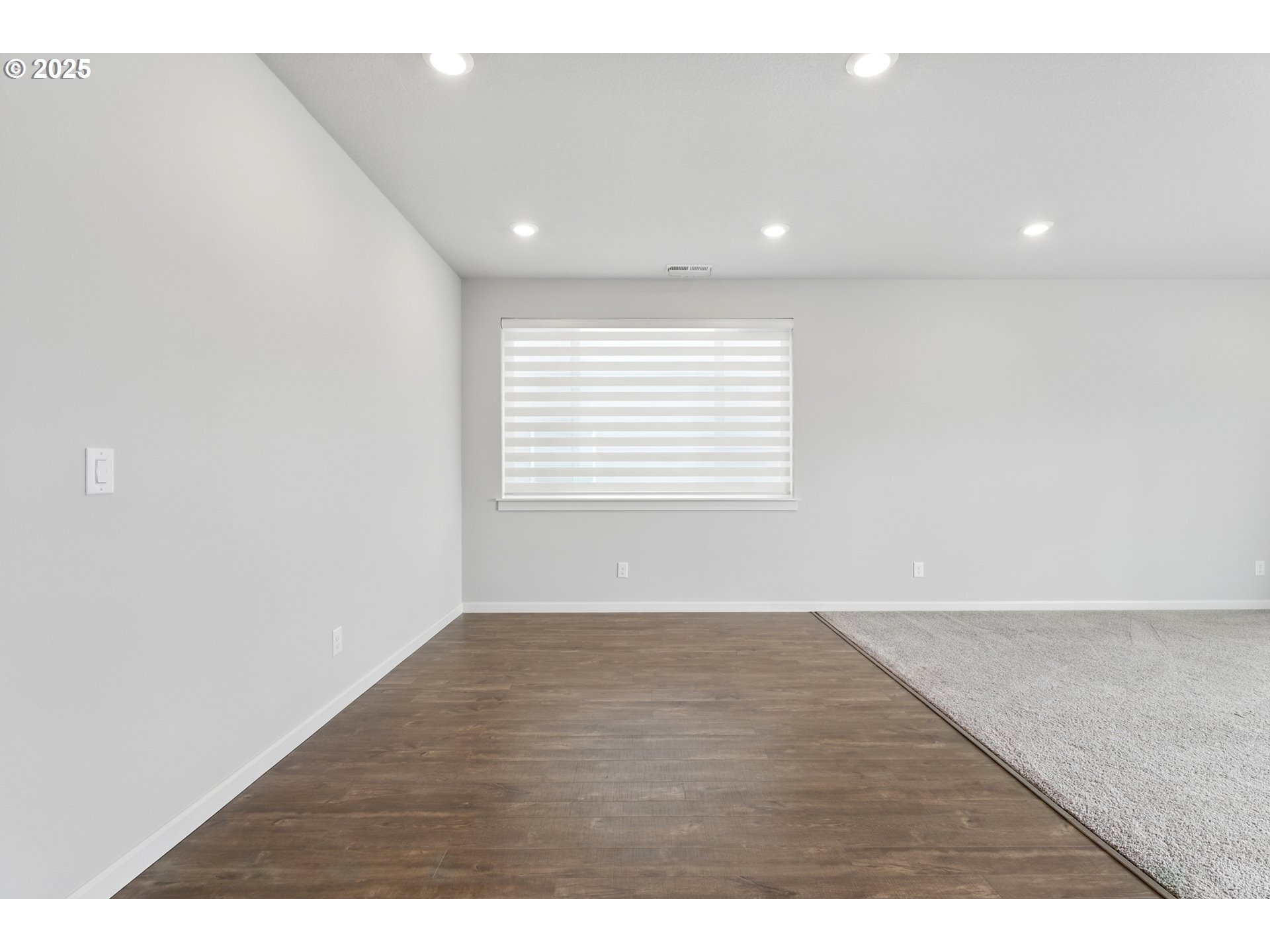 2582 Southwest Thomas Way Gresham, OR 97080 - Photo 10 of 36 a view of an empty room with wooden floor and a window