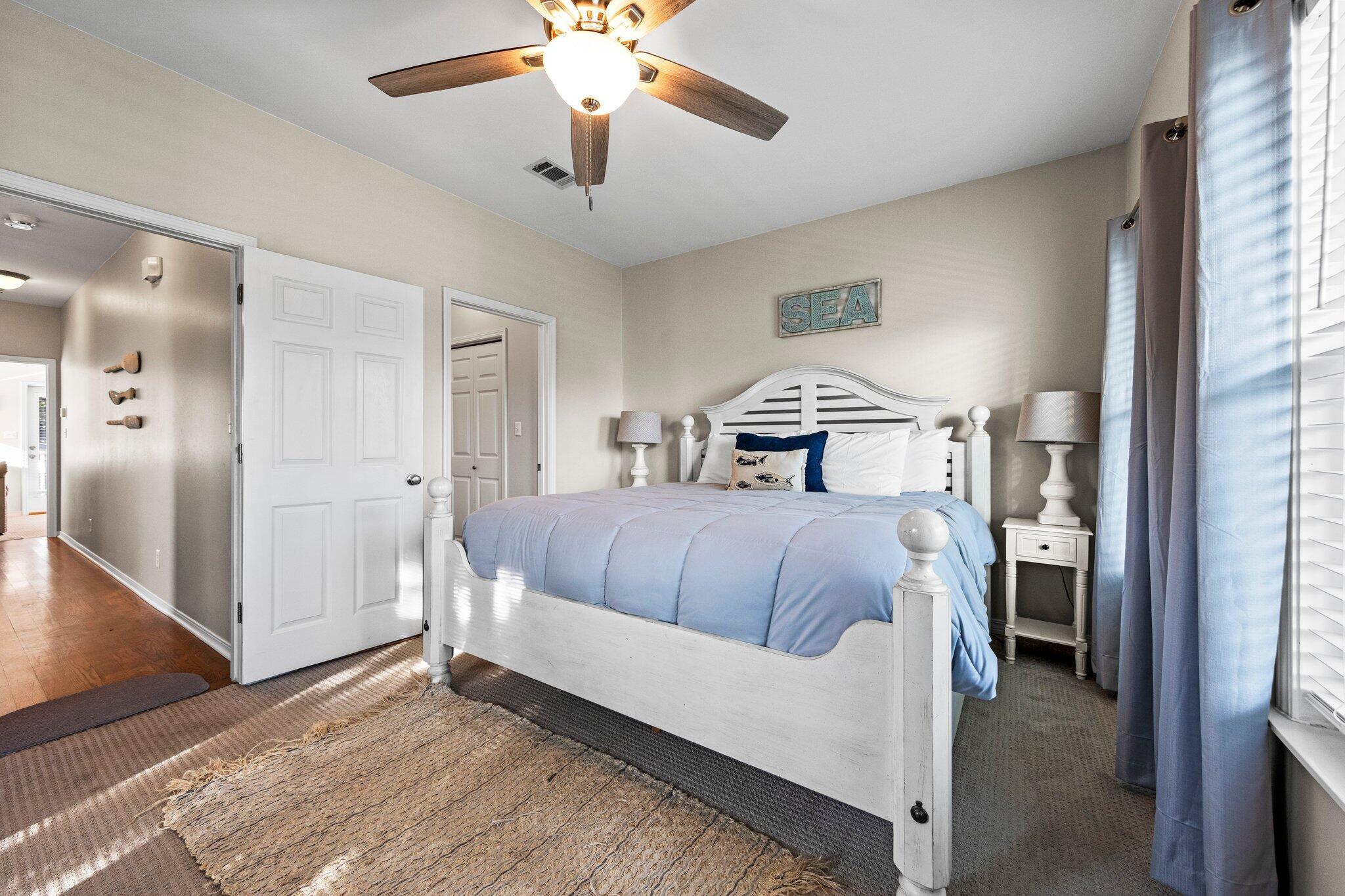 156 Emerald Dunes Circle Santa Rosa Beach, FL 32459 - Photo 11 of 43 a bedroom with a large bed and a chandelier