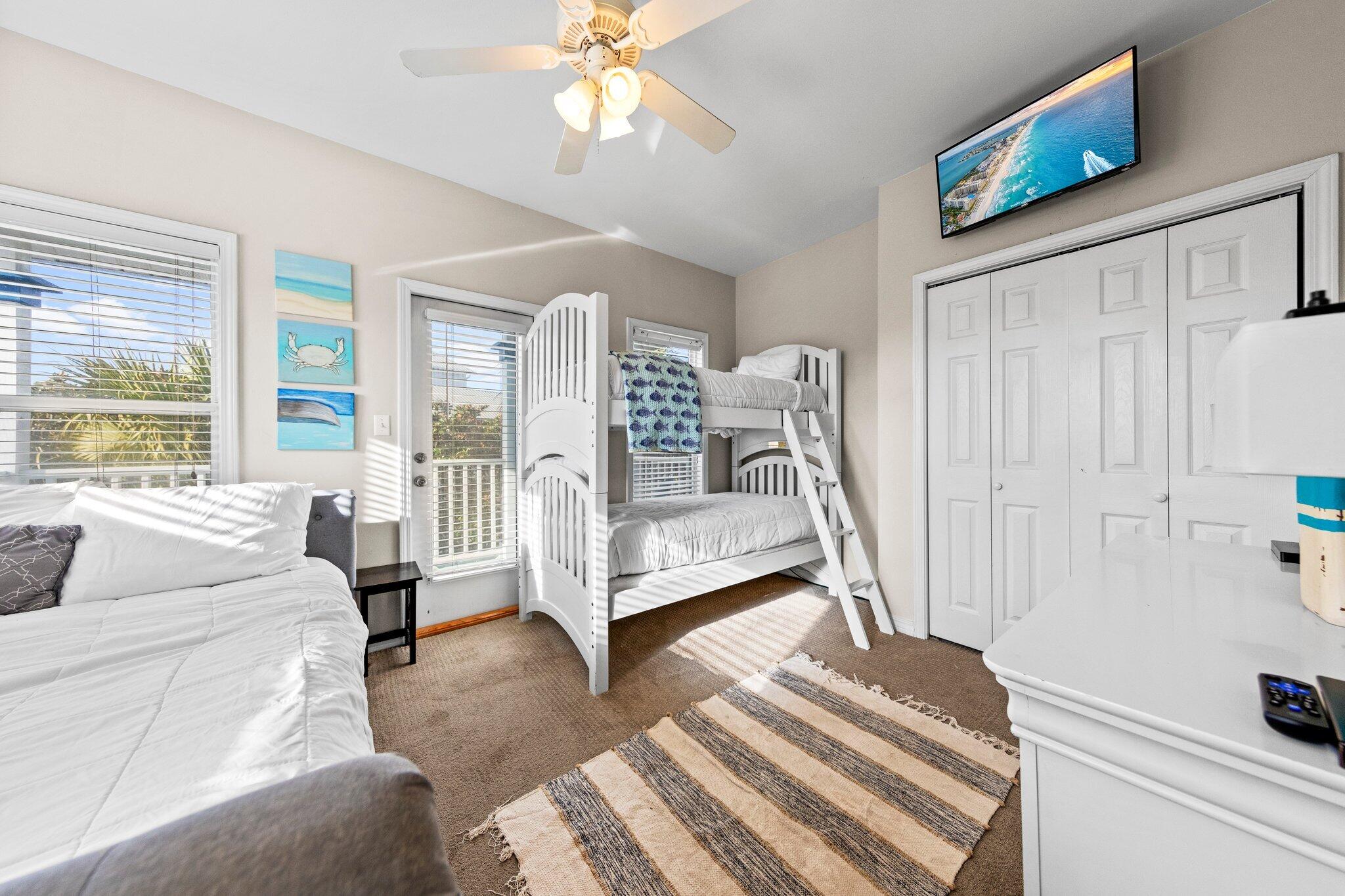 156 Emerald Dunes Circle Santa Rosa Beach, FL 32459 - Photo 20 of 43 a spacious bedroom with a bed a couch and a window