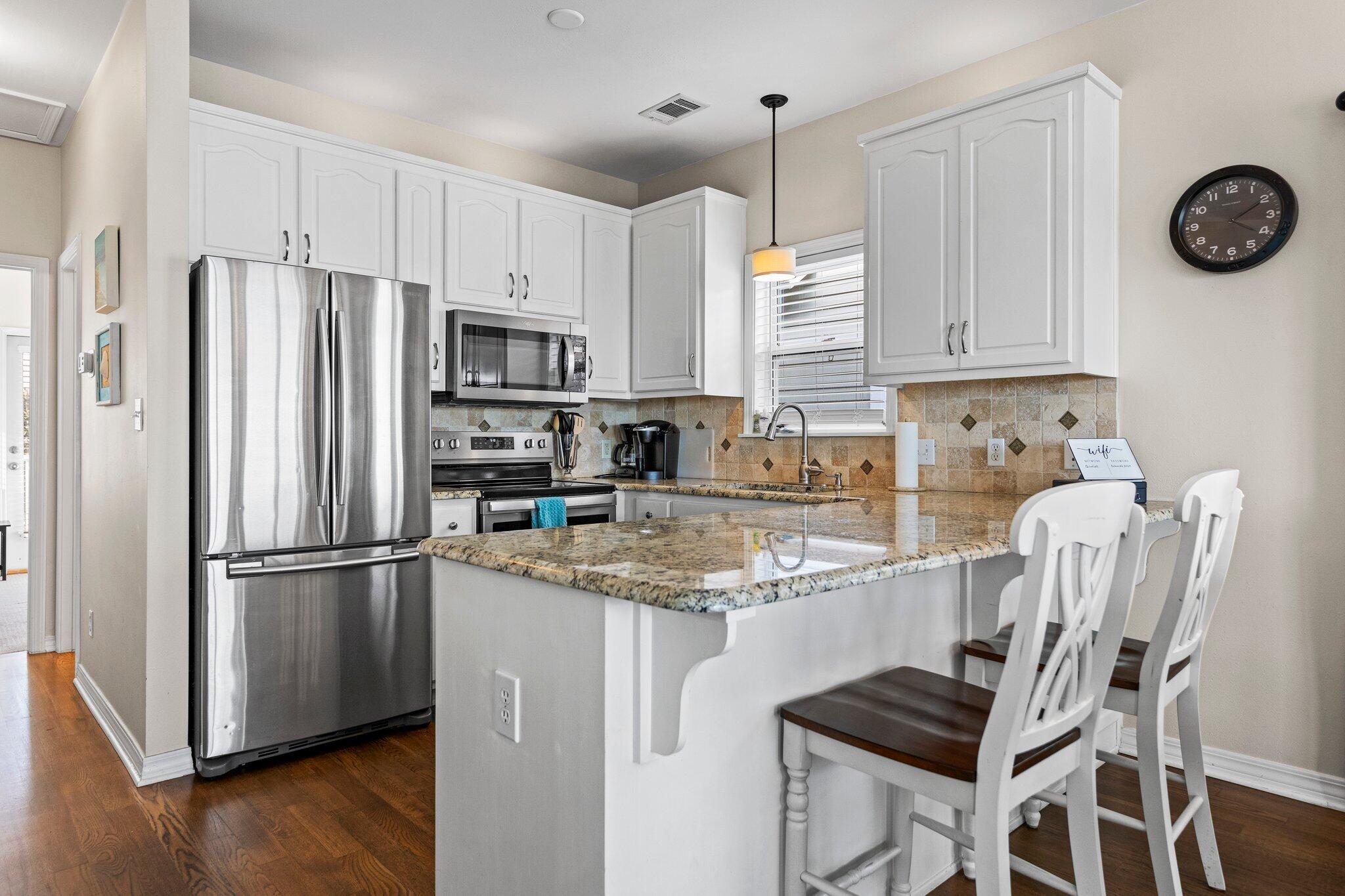 156 Emerald Dunes Circle Santa Rosa Beach, FL 32459 - Photo 7 of 43 a kitchen with stainless steel appliances granite countertop a refrigerator a stove a sink and a refrigerator