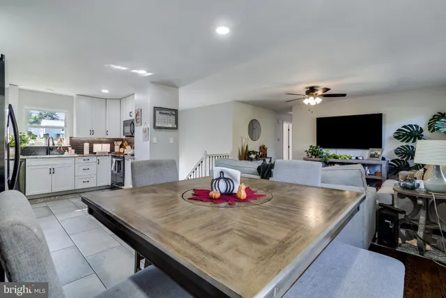 a living room with dining room and flat screen tv