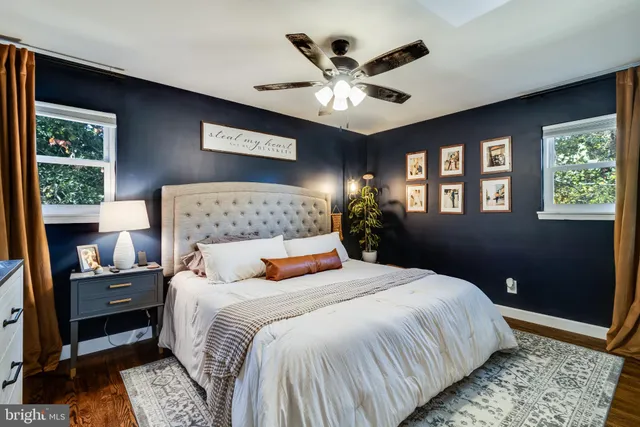 a bedroom with a large bed and a chandelier