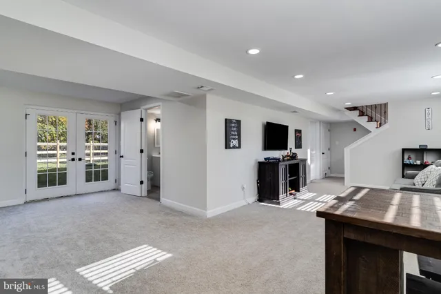 a view of a livingroom with a flat screen tv wooden floor and a fireplace