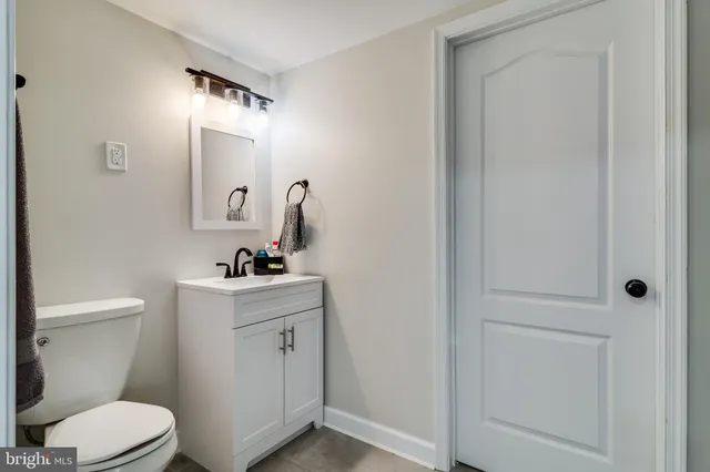 a bathroom with a sink a toilet and mirror