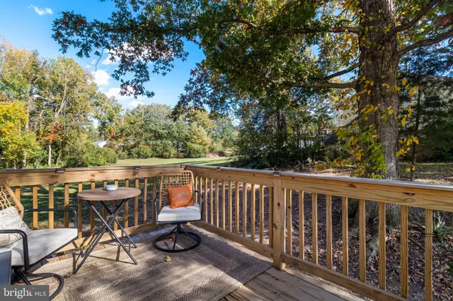 a view of roof deck with furniture and trees