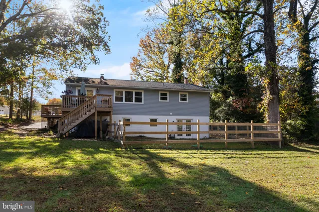 a view of a house with pool and a yard