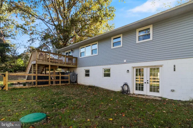 a backyard of a house with wooden fence and porch