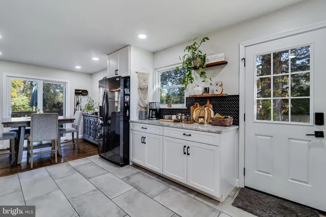 a kitchen with kitchen island granite countertop cabinets and potted plant
