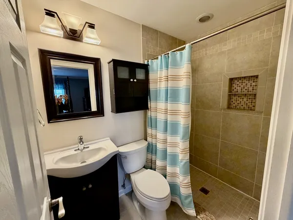 a bathroom with a sink toilet and shower