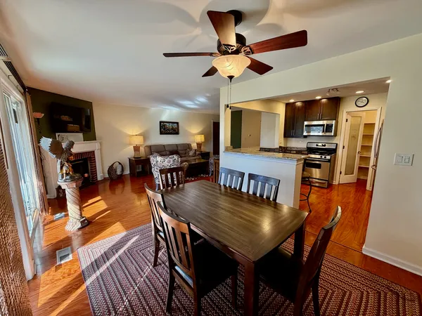 a view of a dining room with furniture and wooden floor