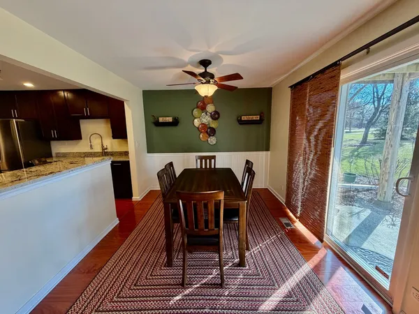 a dining room with furniture a window and wooden floor