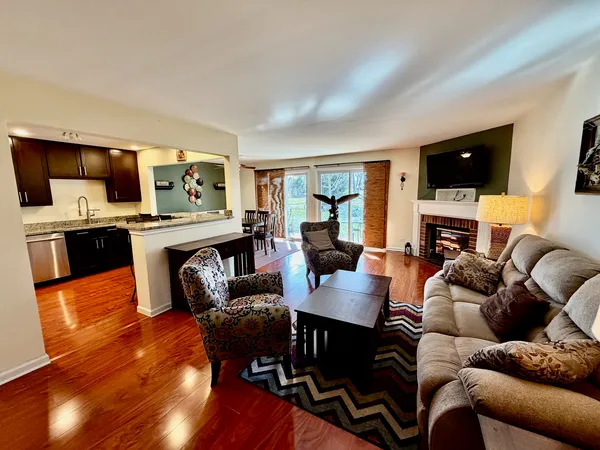 a living room with fireplace furniture and a flat screen tv