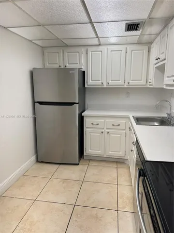 a kitchen with cabinets and white appliances