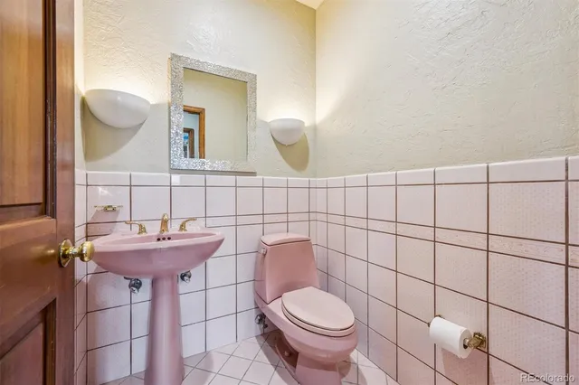 a bathroom with a sink toilet and a mirror