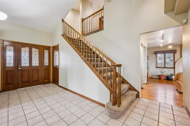 a view of an entryway wooden floor and livingroom
