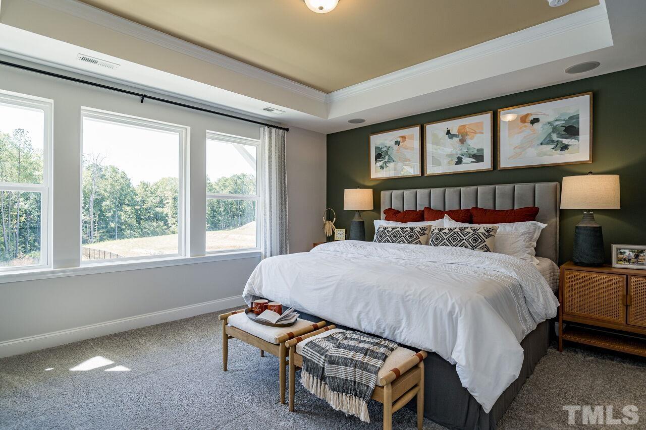 3115 Dunnock Drive, Unit 2 Durham, NC 27713 - Photo 11 of 24 a bed sitting in a bedroom next to a window