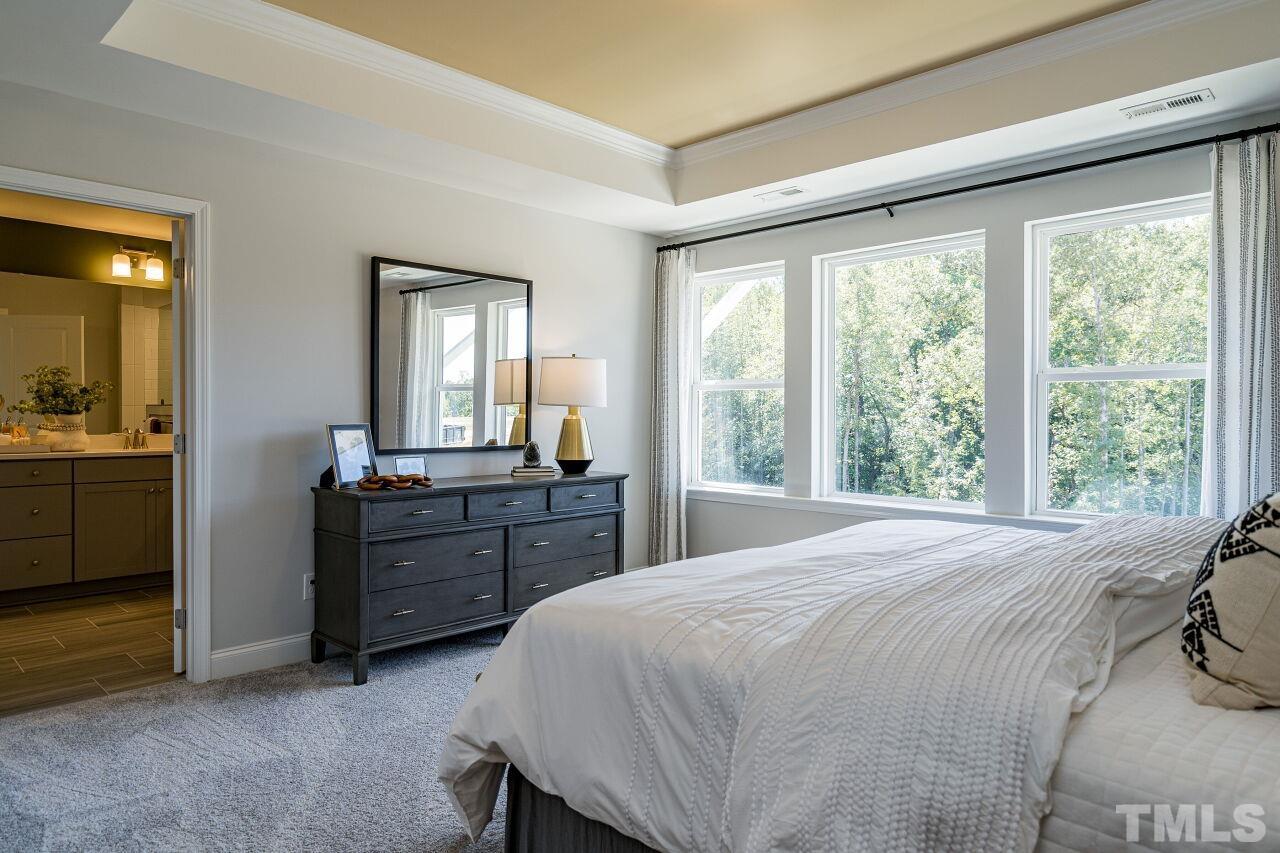 3115 Dunnock Drive, Unit 2 Durham, NC 27713 - Photo 12 of 24 a large bedroom with a large bed and a large window