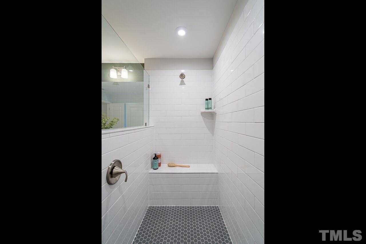 3115 Dunnock Drive, Unit 2 Durham, NC 27713 - Photo 15 of 24 a bathroom with a bathtub and shower