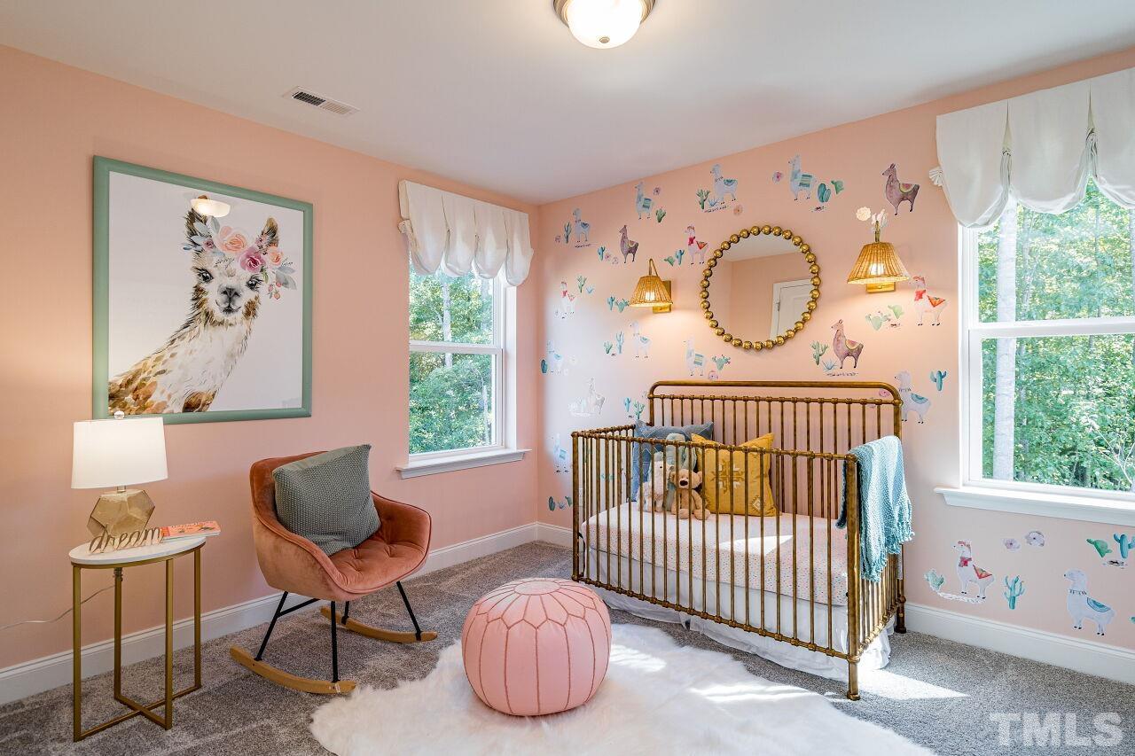 3115 Dunnock Drive, Unit 2 Durham, NC 27713 - Photo 17 of 24 a bedroom with furniture and a window