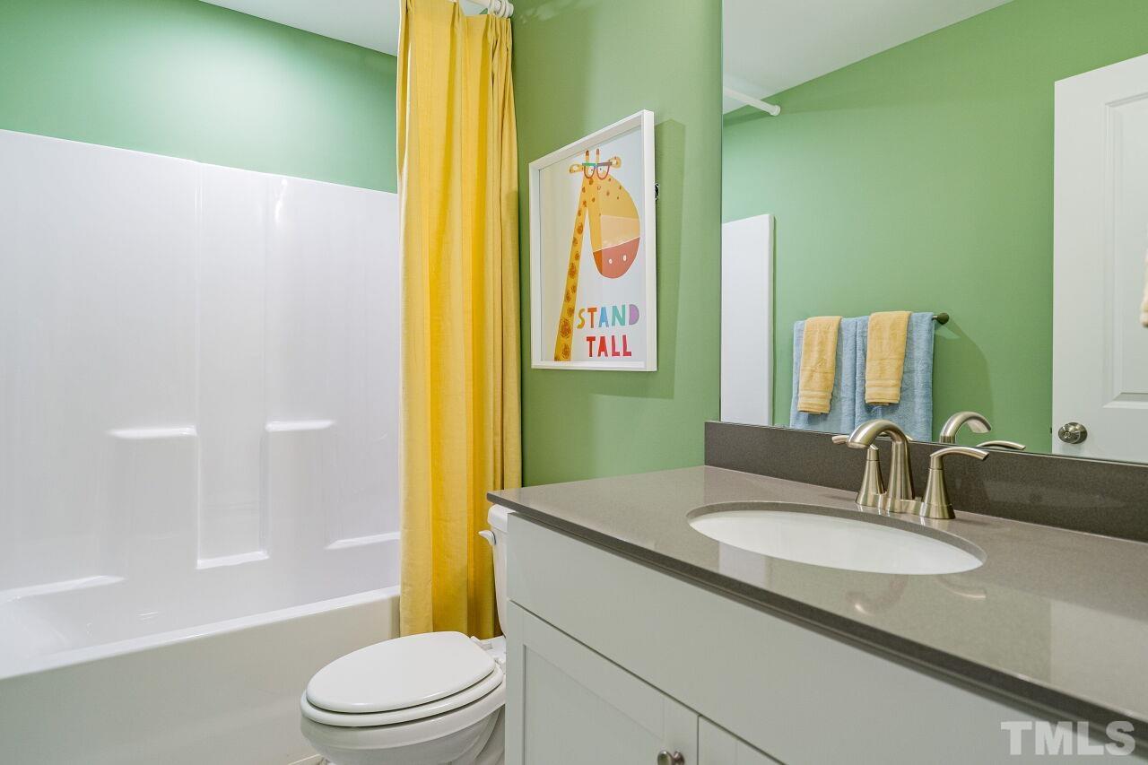 3115 Dunnock Drive, Unit 2 Durham, NC 27713 - Photo 18 of 24 a bathroom with a granite countertop sink and a mirror