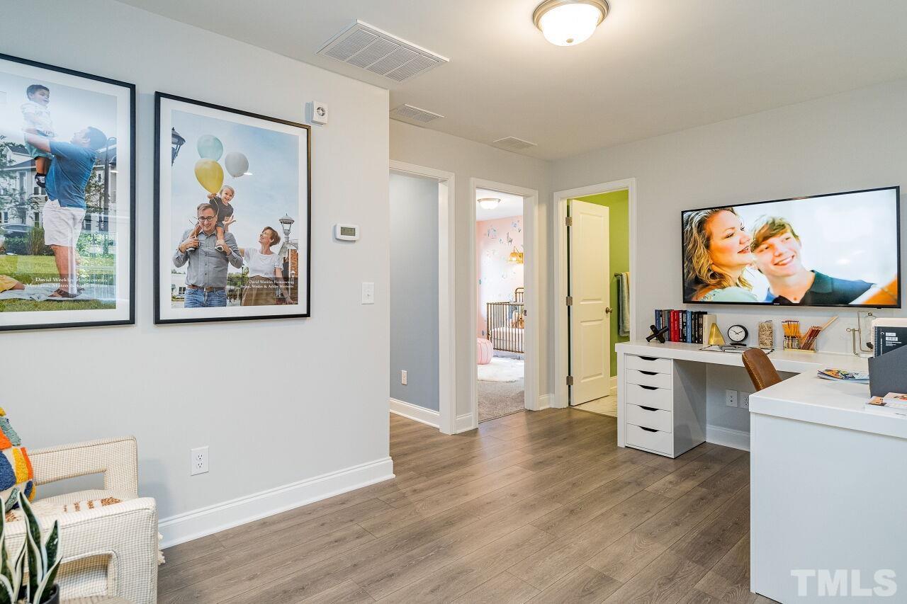 3115 Dunnock Drive, Unit 2 Durham, NC 27713 - Photo 21 of 24 a view of a workspace with furniture and wooden floor