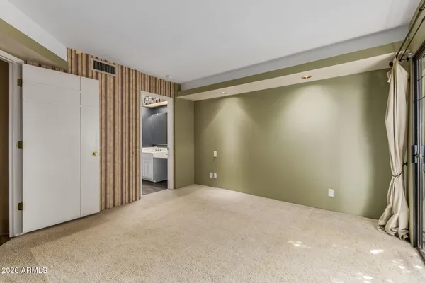 a view of an empty room with glass door