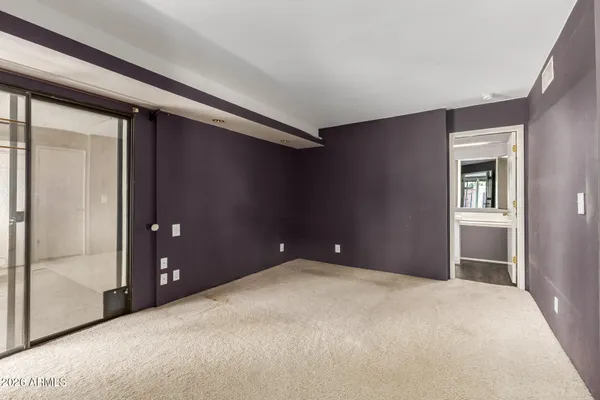 a view of a big room with windows and entryway