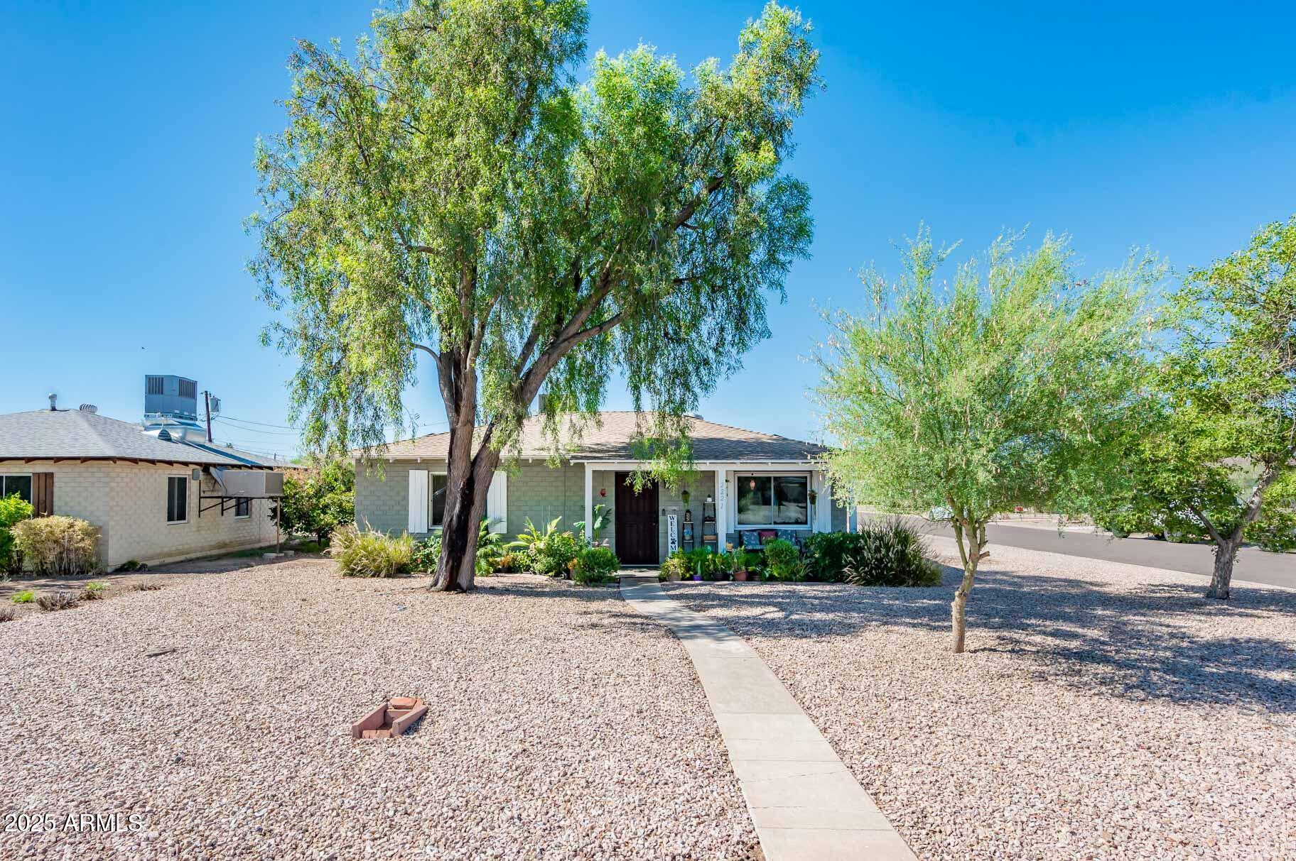 2221 West Mitchell Drive Phoenix, AZ 85015 - Photo 14 of 45 a front view of a house with a yard and tree s