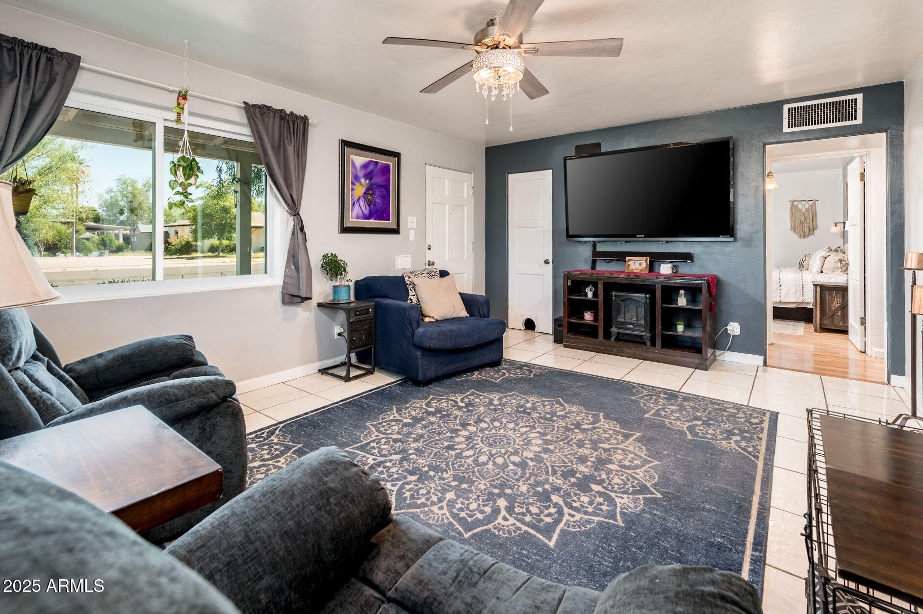 2221 West Mitchell Drive Phoenix, AZ 85015 - Photo 15 of 45 a living room with furniture and a flat screen tv