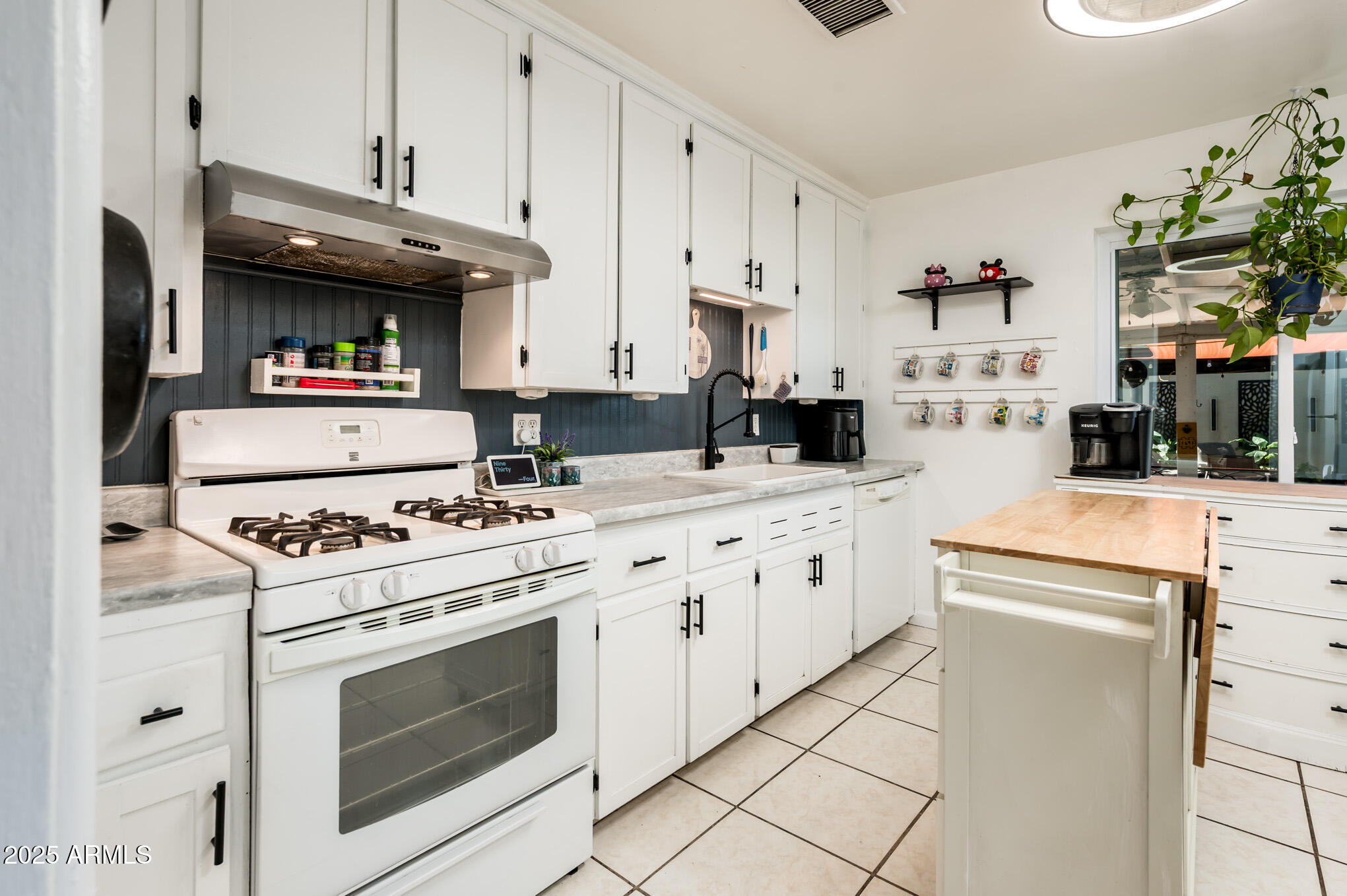 2221 West Mitchell Drive Phoenix, AZ 85015 - Photo 17 of 45 a kitchen with stainless steel appliances granite countertop a stove and a cabinets