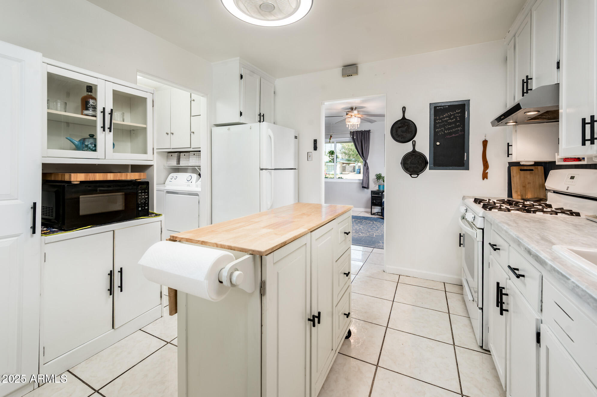 2221 West Mitchell Drive Phoenix, AZ 85015 - Photo 19 of 45 a kitchen with white cabinets and white appliances
