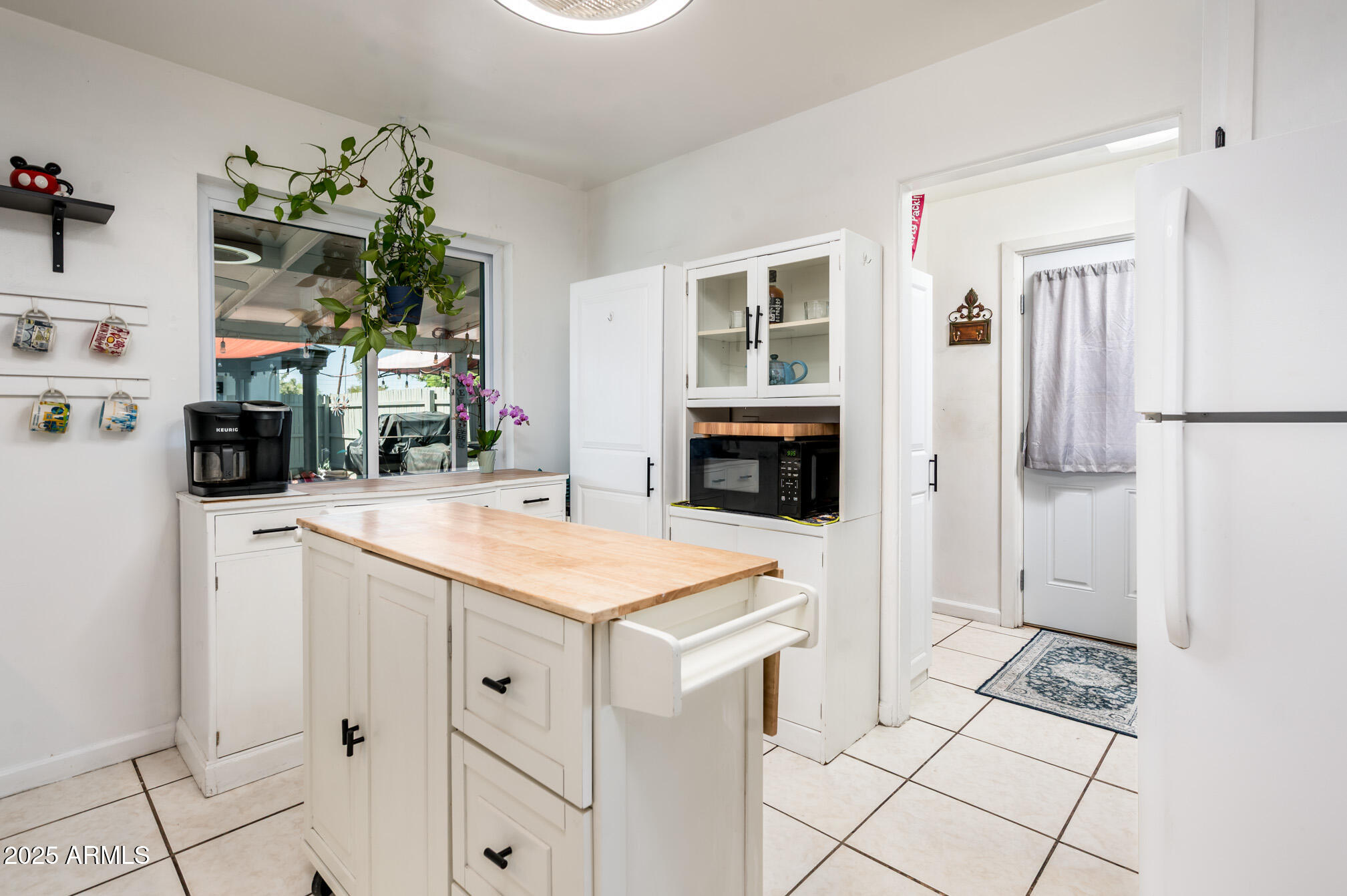 2221 West Mitchell Drive Phoenix, AZ 85015 - Photo 20 of 45 a kitchen with stainless steel appliances kitchen island granite countertop a refrigerator a stove a sink dishwasher and white cabinets with wooden floor