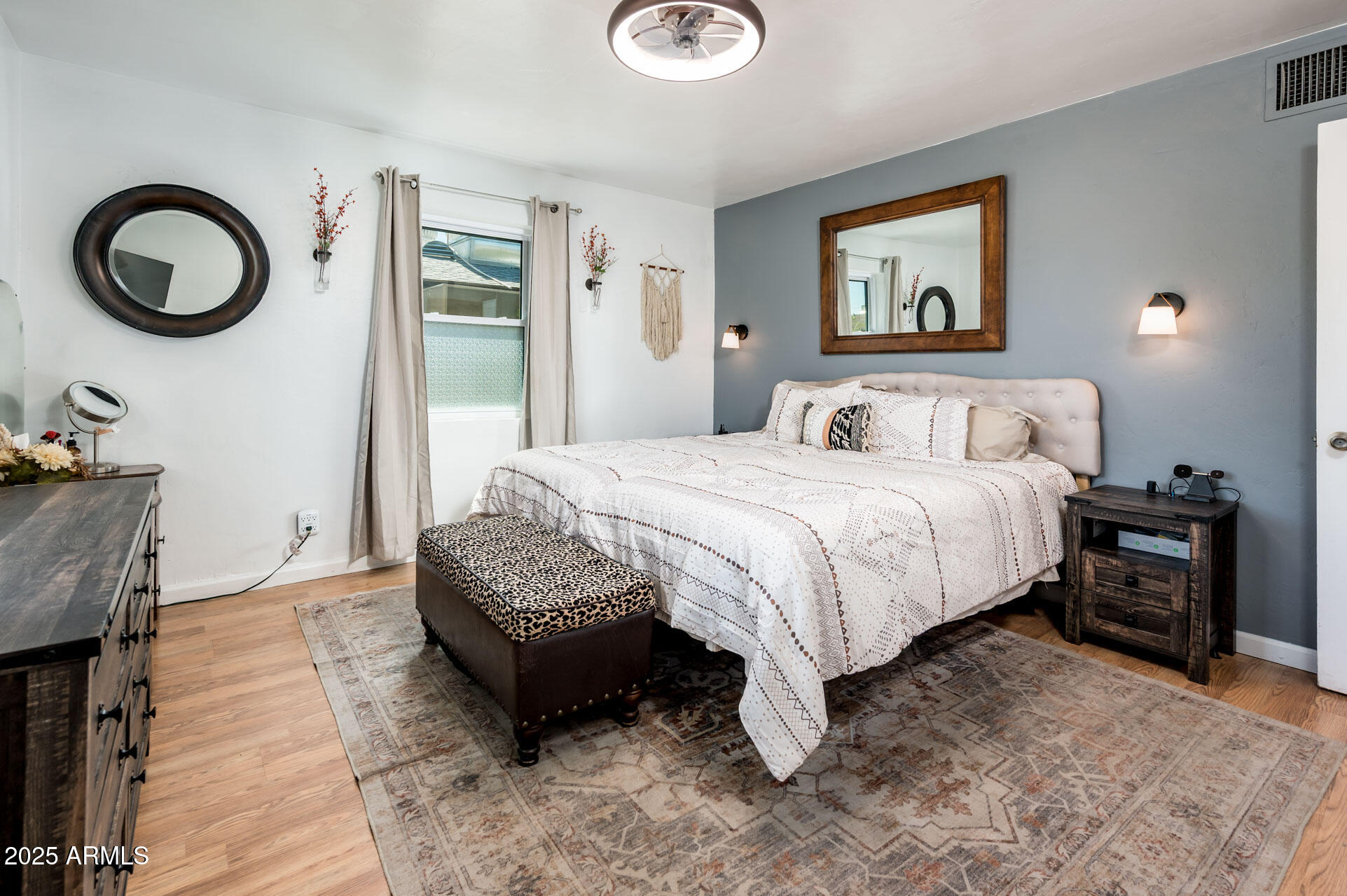 2221 West Mitchell Drive Phoenix, AZ 85015 - Photo 22 of 45 a bedroom with a bed a wall painting and a painting on the wall