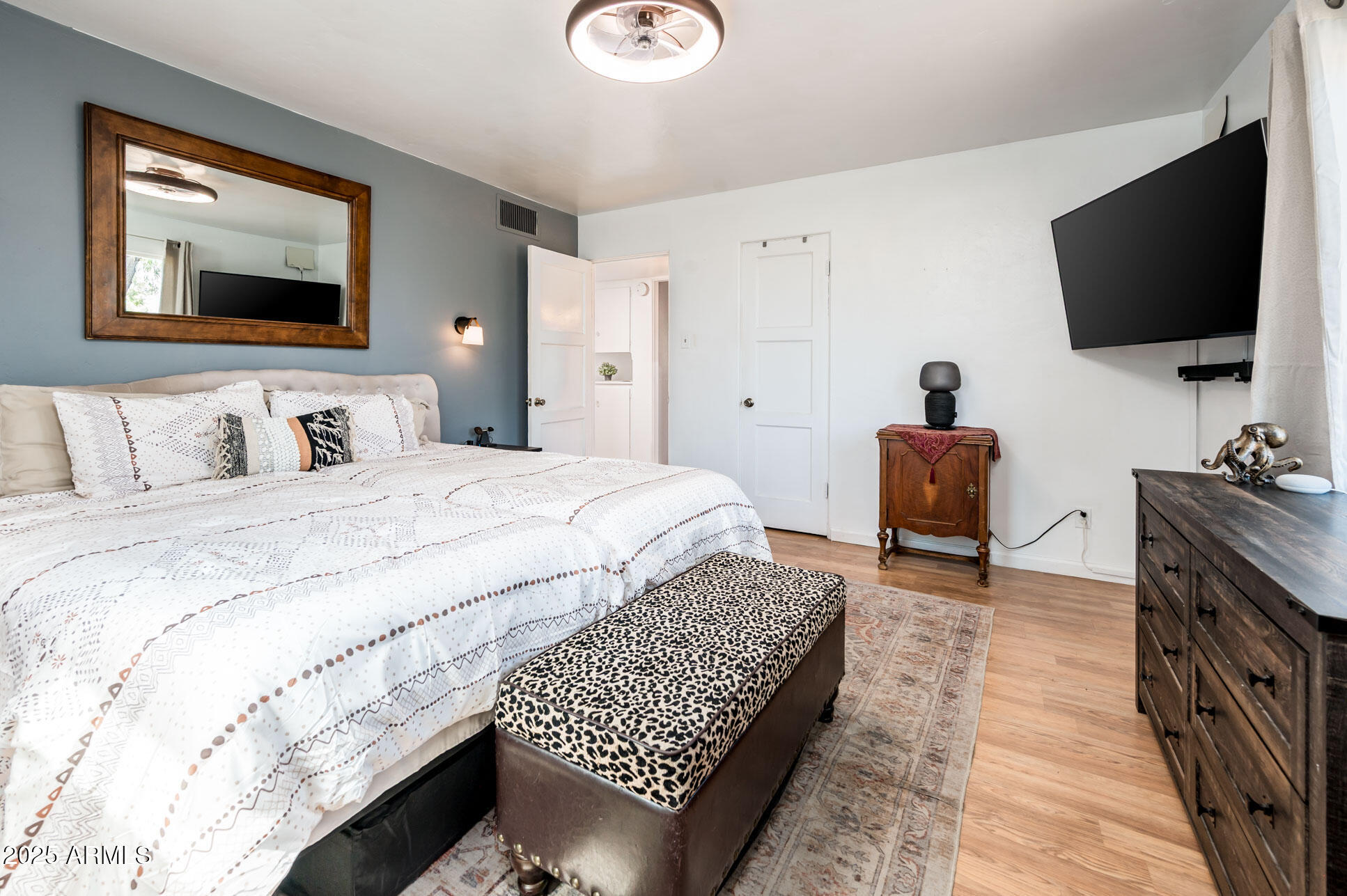 2221 West Mitchell Drive Phoenix, AZ 85015 - Photo 23 of 45 a spacious bedroom with a bed and a flat screen television