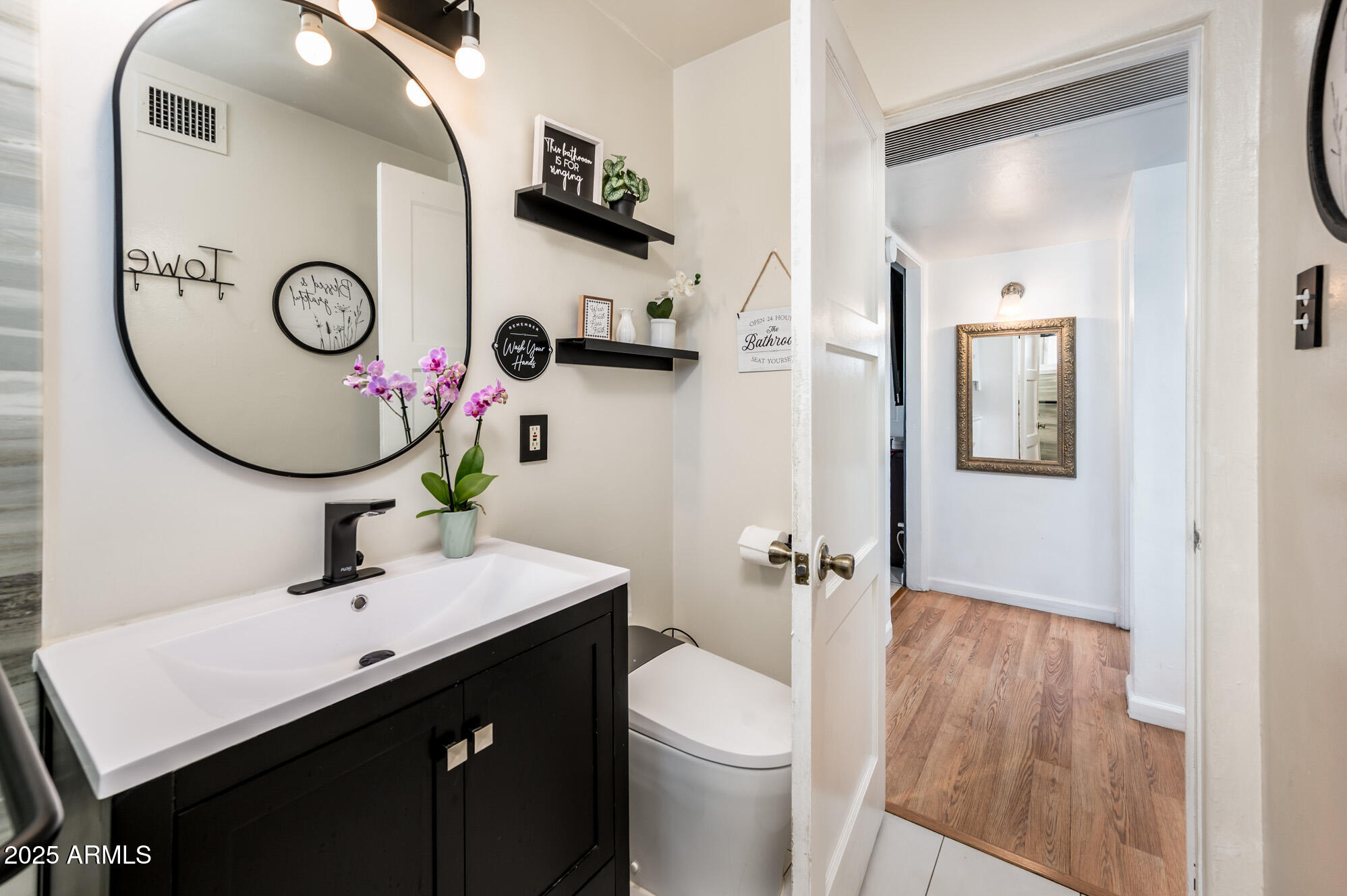 2221 West Mitchell Drive Phoenix, AZ 85015 - Photo 27 of 45 a bathroom with a sink a toilet and a mirror