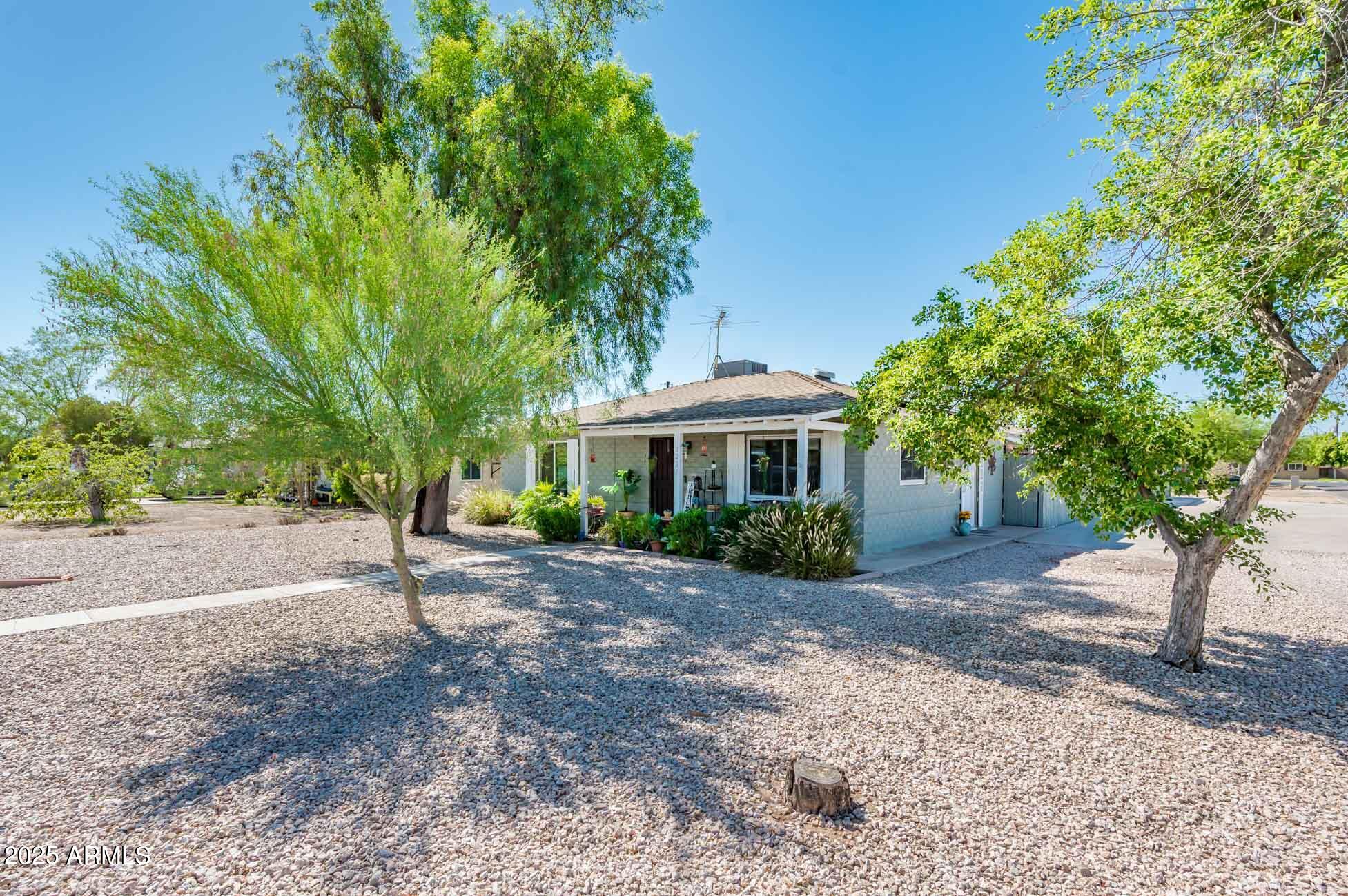 2221 West Mitchell Drive Phoenix, AZ 85015 - Photo 2 of 45 a front view of a house with a yard and trees