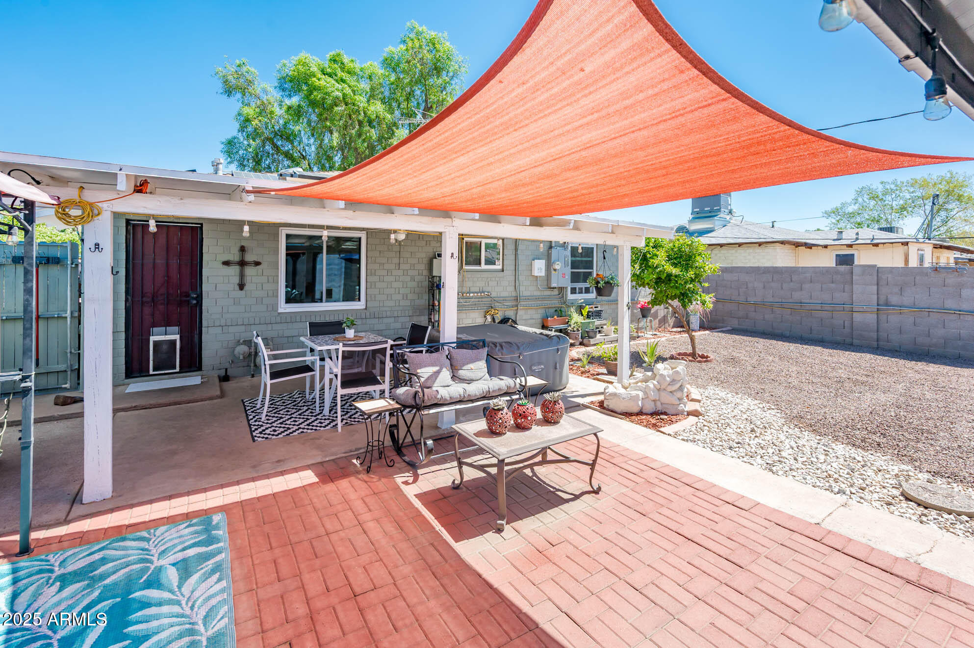 2221 West Mitchell Drive Phoenix, AZ 85015 - Photo 31 of 45 a view of a patio with table and chairs under an umbrella with wooden floor