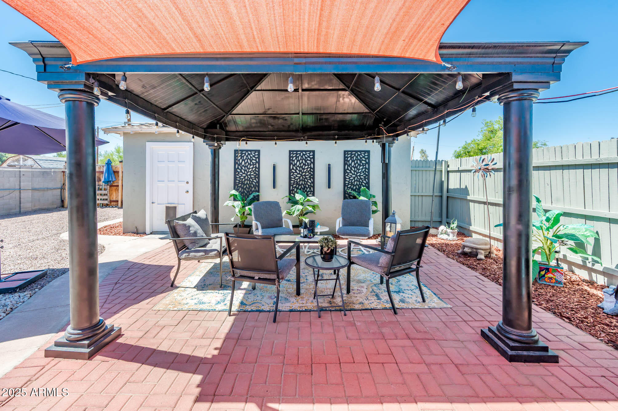 2221 West Mitchell Drive Phoenix, AZ 85015 - Photo 32 of 45 a view of patio with table and chairs potted plants and floor to ceiling window
