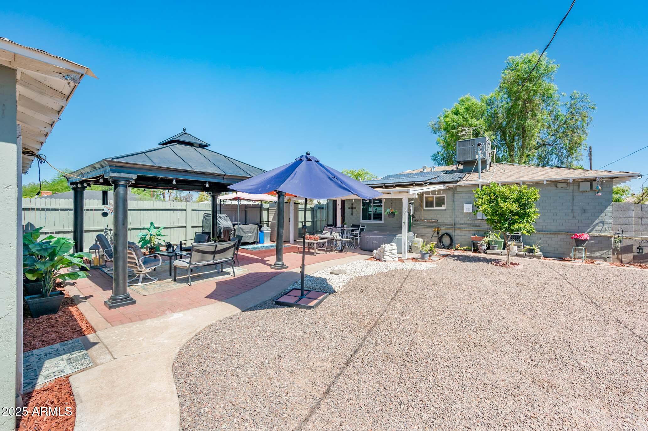 2221 West Mitchell Drive Phoenix, AZ 85015 - Photo 33 of 45 a patio with a table and chairs under an umbrella