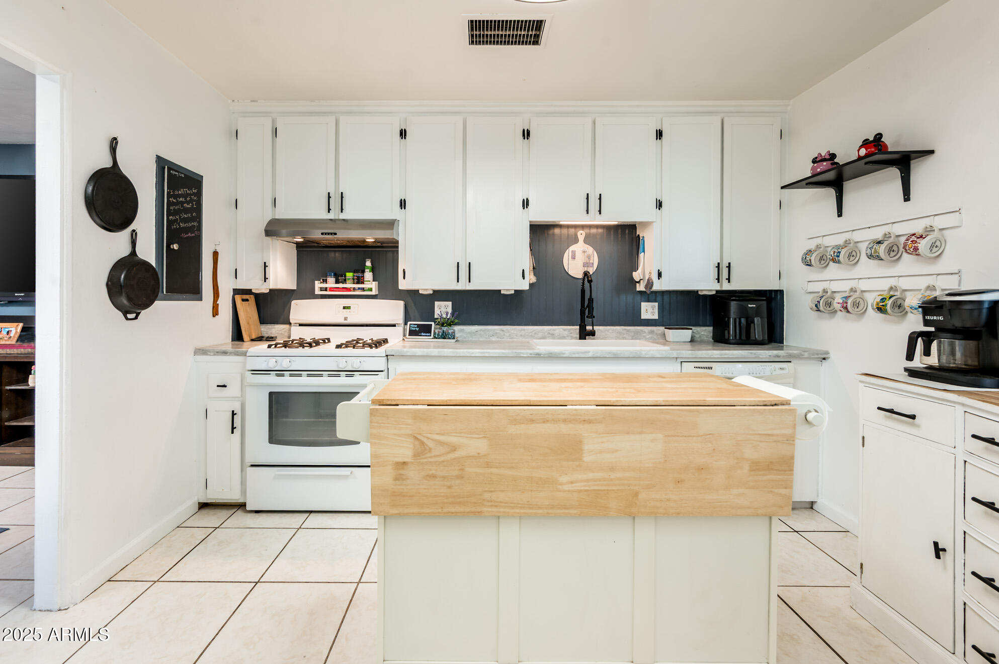 2221 West Mitchell Drive Phoenix, AZ 85015 - Photo 5 of 45 a kitchen with kitchen island granite countertop a stove a sink and a refrigerator