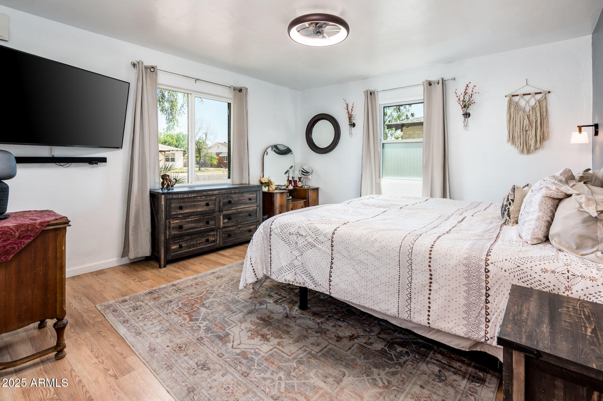 2221 West Mitchell Drive Phoenix, AZ 85015 - Photo 6 of 45 a bedroom with a bed and a flat screen tv